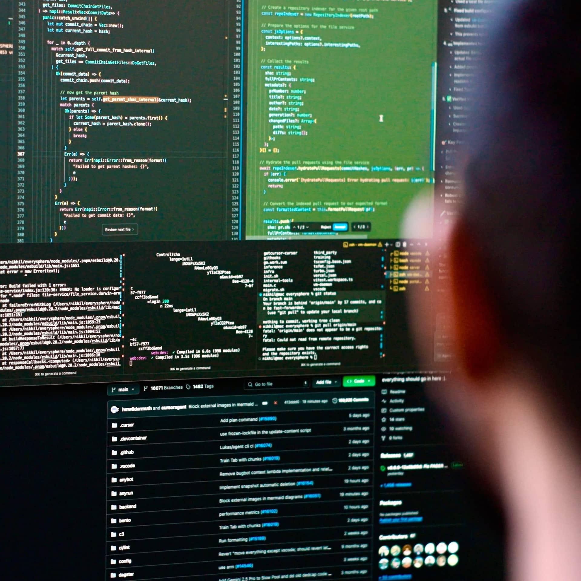 An engineer at Cursor working with source code across two monitors.